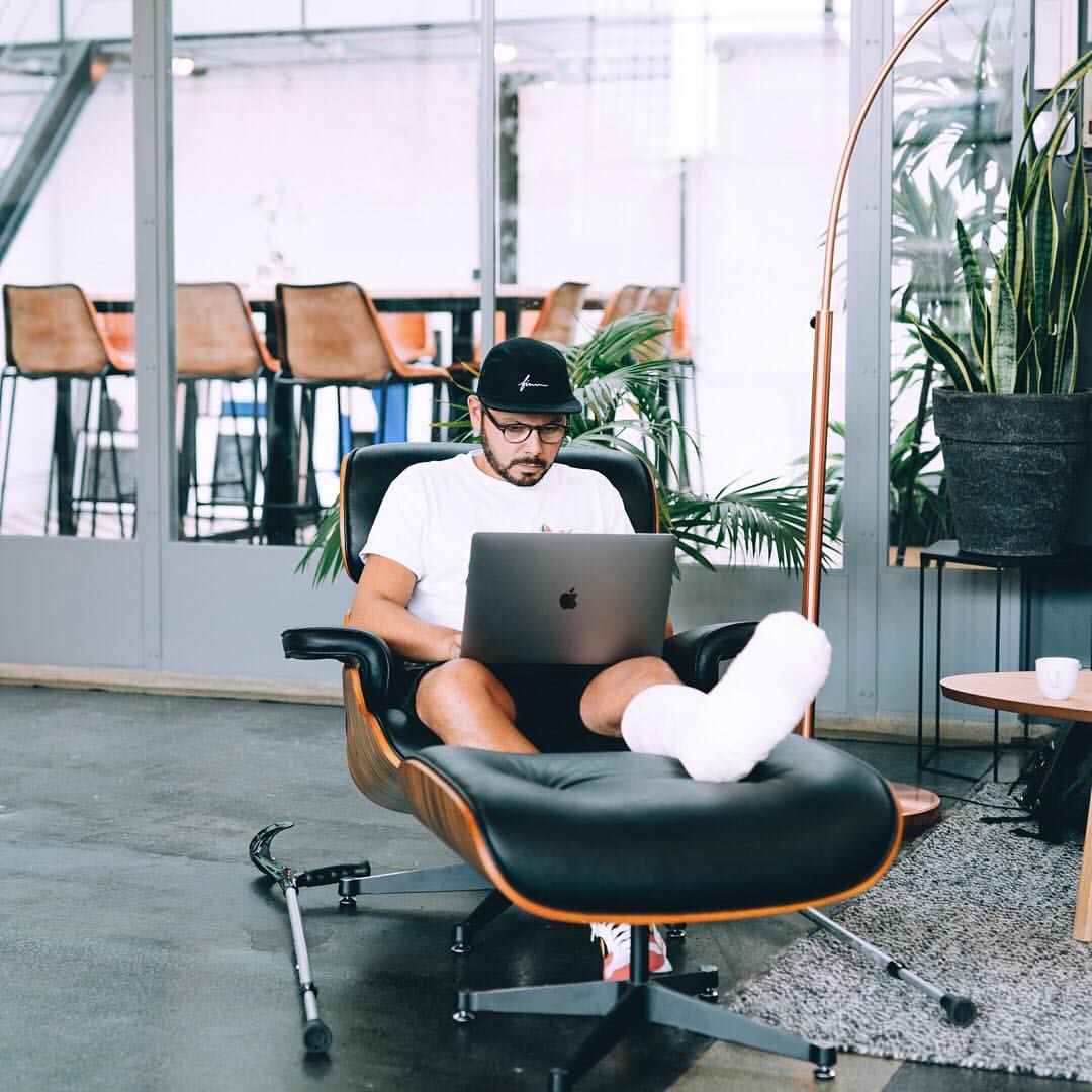 Account manager writing a status report for his client in an Eames Lounge Chair