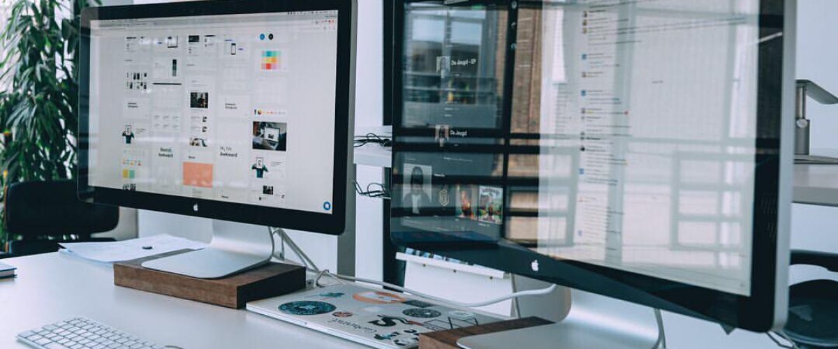 Two Apple Cinema Displays on a desk